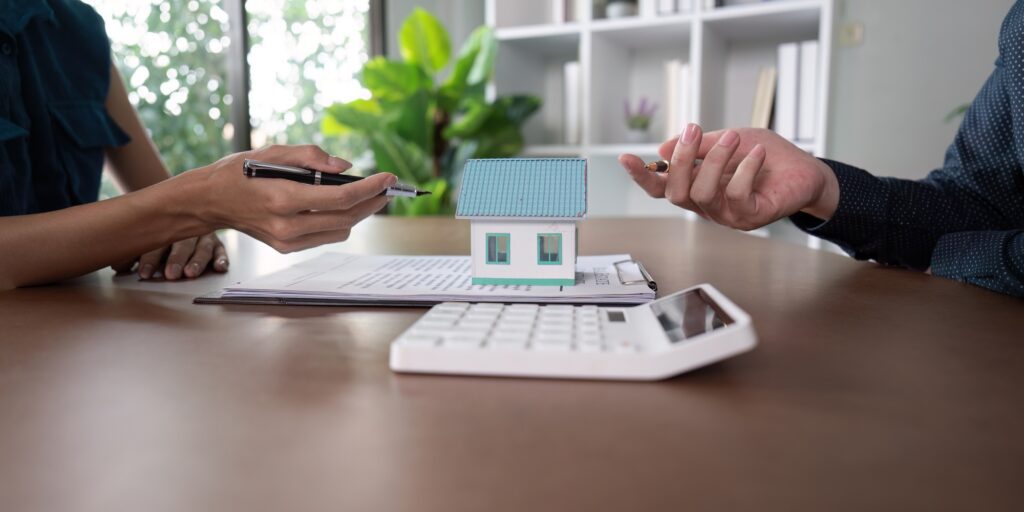 Discussing property details over a contract and house model