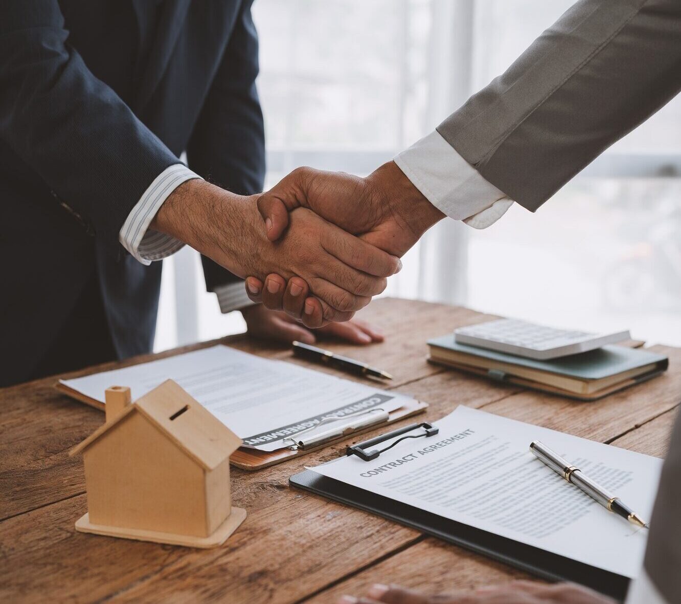 Handshake of real estate brokers with customers or investors, mortgage loan agreements Make a lease-
