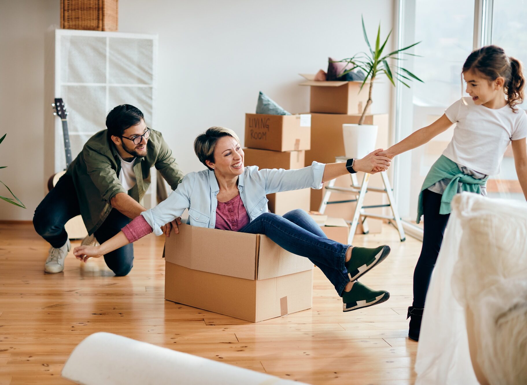 Playful family having fun together while moving into their new house.
